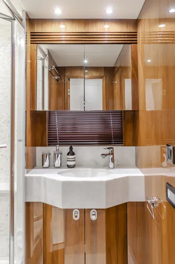 Agua Rancho Yacht Photos Pics Luxurious bathroom interior of 2017 Sunseeker 75 Yacht with modern fixtures and wood paneling.