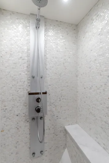 Agua Rancho Yacht Photos Pics Luxurious shower in 2017 Sunseeker 75 Yacht with modern fixtures and white mosaic tiles.