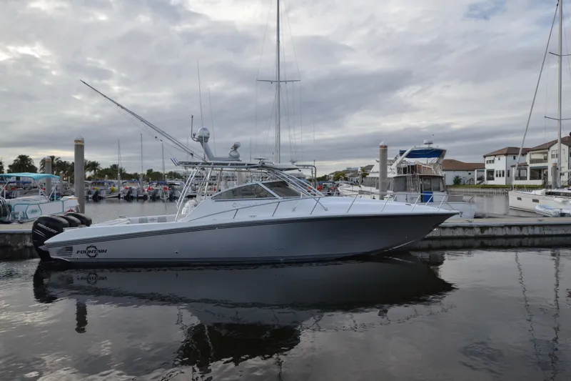 Flying Norseman II Yacht Photos Pics 2007 Fountain 38 Sportfish Cruiser OB docked in a marina, overcast sky.