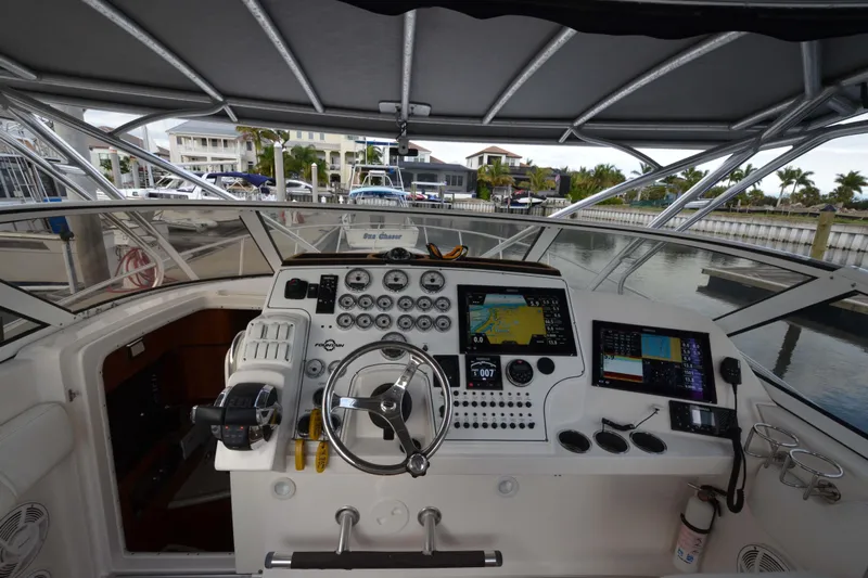 Flying Norseman II Yacht Photos Pics 2007 Fountain 38 Sportfish Cruiser OB helm with navigation screens and controls at marina.