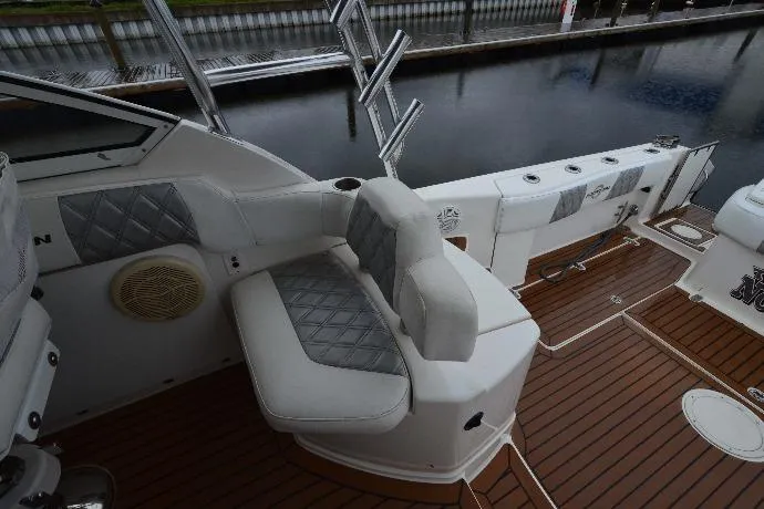 Flying Norseman II Yacht Photos Pics 2007 Fountain 38 Sportfish Cruiser OB interior with cushioned seating and wood flooring.