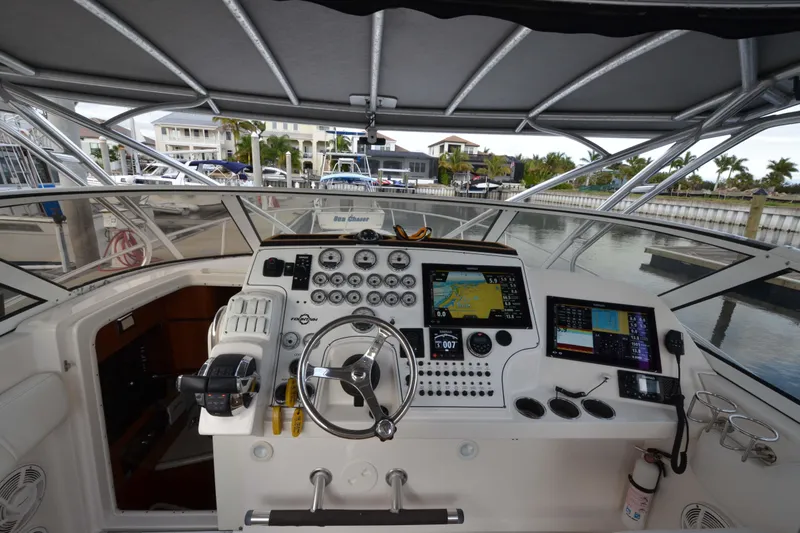 Flying Norseman II Yacht Photos Pics 2007 Fountain 38 Sportfish Cruiser OB helm with navigation screens and controls at marina.