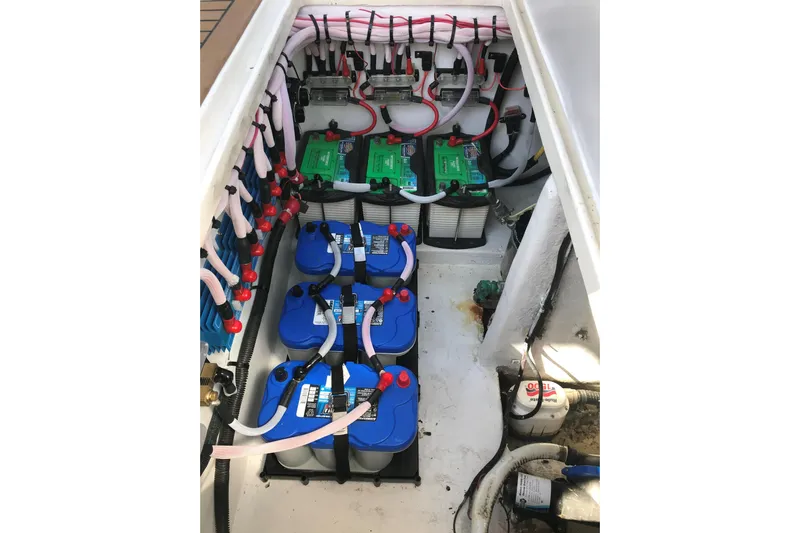 Flying Norseman II Yacht Photos Pics 2007 Fountain 38 Sportfish Cruiser OB battery compartment with organized wiring and multiple batteries.