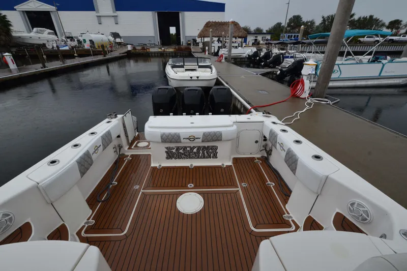 Flying Norseman II Yacht Photos Pics 2007 Fountain 38 Sportfish Cruiser OB at marina, featuring spacious deck and outboard engines.