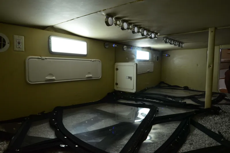 Flying Norseman II Yacht Photos Pics 2007 Fountain 38 Sportfish Cruiser OB interior storage area with lighting and access panels.