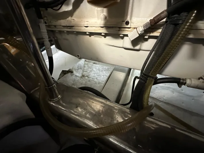 Miss Stephanie Yacht Photos Pics Engine compartment of a 2008 Marlow 70 Explorer yacht with visible hoses and wiring.