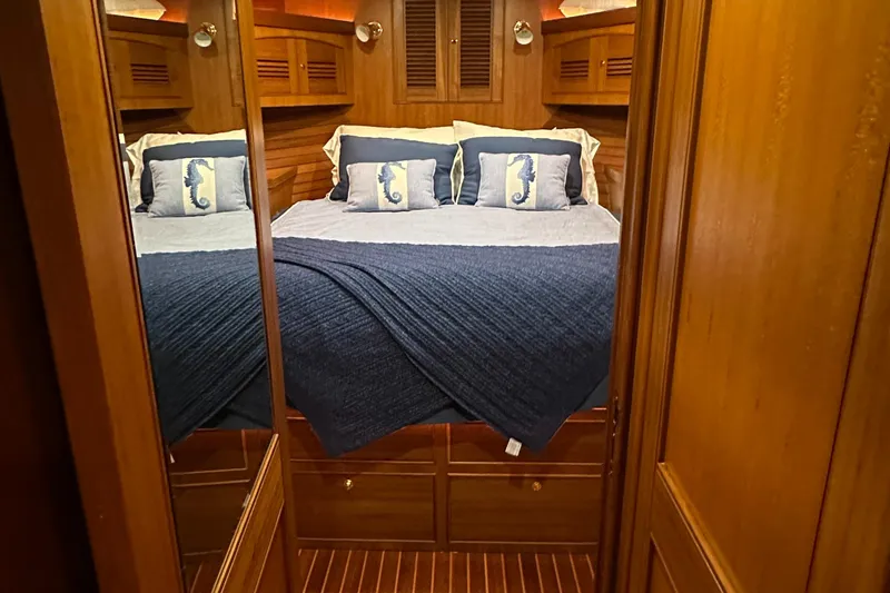 Miss Stephanie Yacht Photos Pics Luxurious bedroom in 2008 Marlow 70 Explorer yacht with cozy bedding and wooden interior.