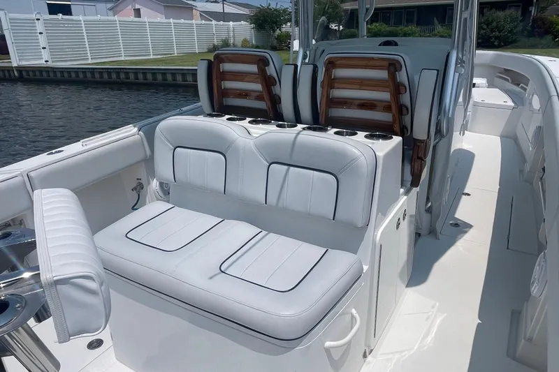  Yacht Photos Pics 2020 Jupiter 38 boat interior with white cushioned seating and cup holders.