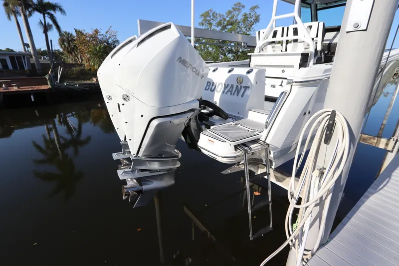  Yacht Photos Pics 2023 Blackfin 272 CC boat with Mercury outboard motor docked by water.