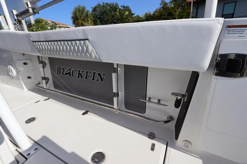  Yacht Photos Pics 2023 Blackfin 272 CC boat interior with branded storage compartment and sleek design.