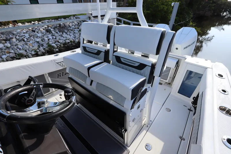 Yacht Photos Pics 2023 Blackfin 272 CC boat interior with dual seating and steering wheel.