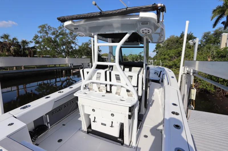  Yacht Photos Pics 2023 Blackfin 272 CC boat docked, featuring a sleek design and spacious deck.