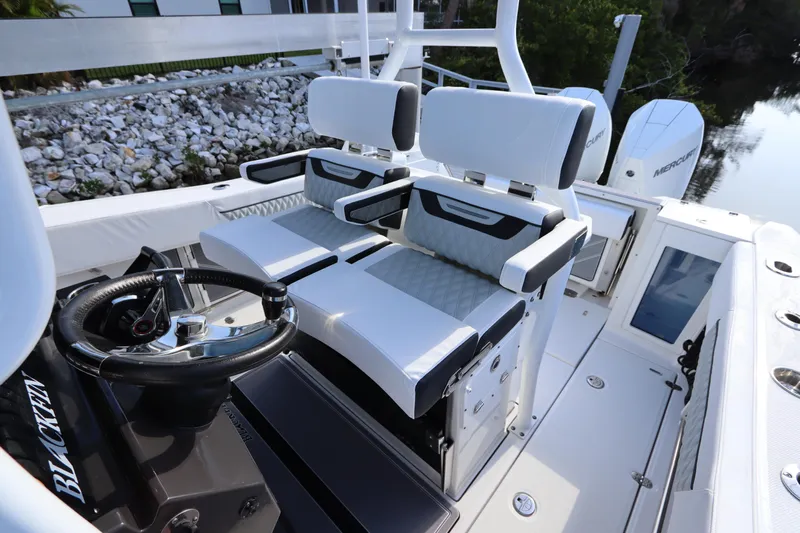  Yacht Photos Pics 2023 Blackfin 272 CC boat interior with dual helm seats and steering wheel.