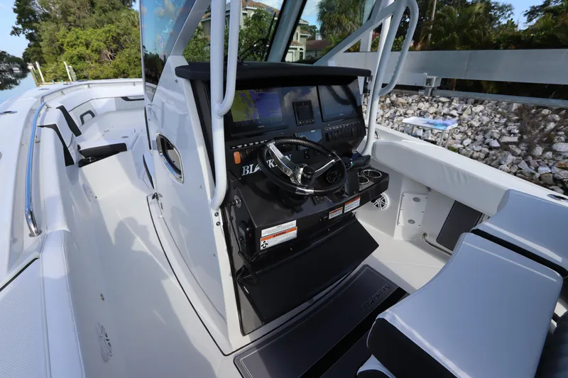  Yacht Photos Pics 2023 Blackfin 272 CC boat cockpit with modern controls and seating.