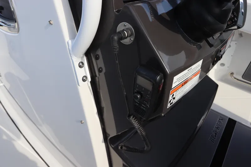  Yacht Photos Pics 2023 Blackfin 272 CC boat console with radio and safety instructions.