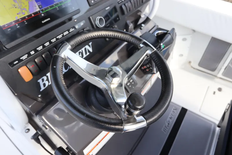  Yacht Photos Pics 2023 Blackfin 272 CC steering wheel and dashboard with navigation display.