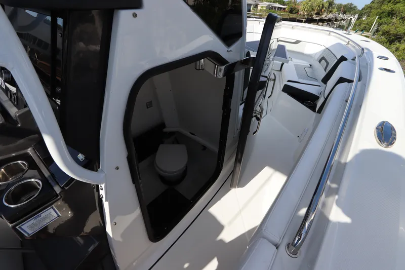  Yacht Photos Pics 2023 Blackfin 272 CC boat interior with open cabin door and visible toilet.