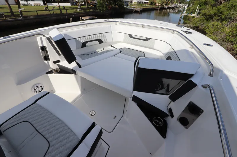  Yacht Photos Pics 2023 Blackfin 272 CC boat interior with cushioned seating and sleek design.