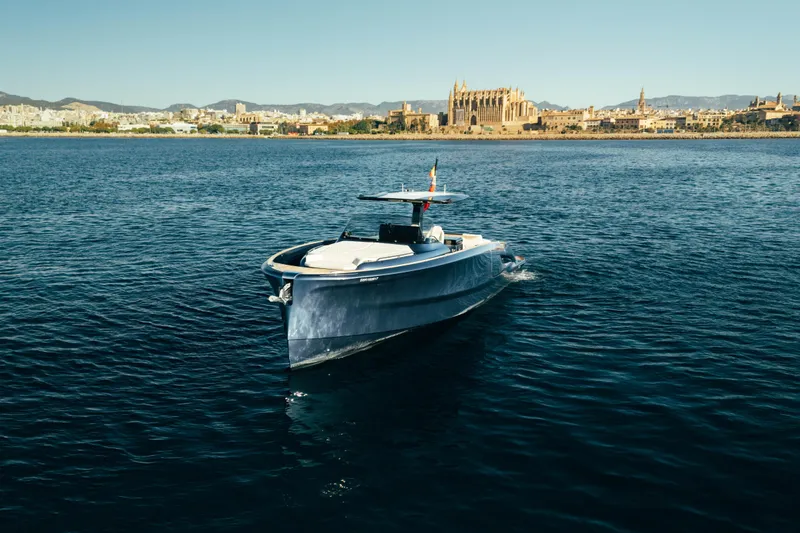  Yacht Photos Pics 2023 Solaris Power 44 Open yacht cruising near a historic coastal city.