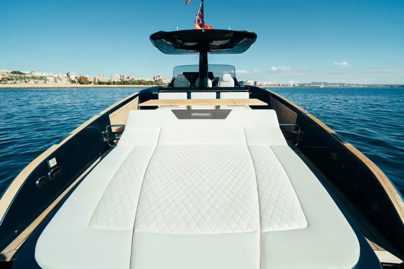  Yacht Photos Pics 2023 Solaris Power 44 Open yacht with luxurious sunbed on calm waters.
