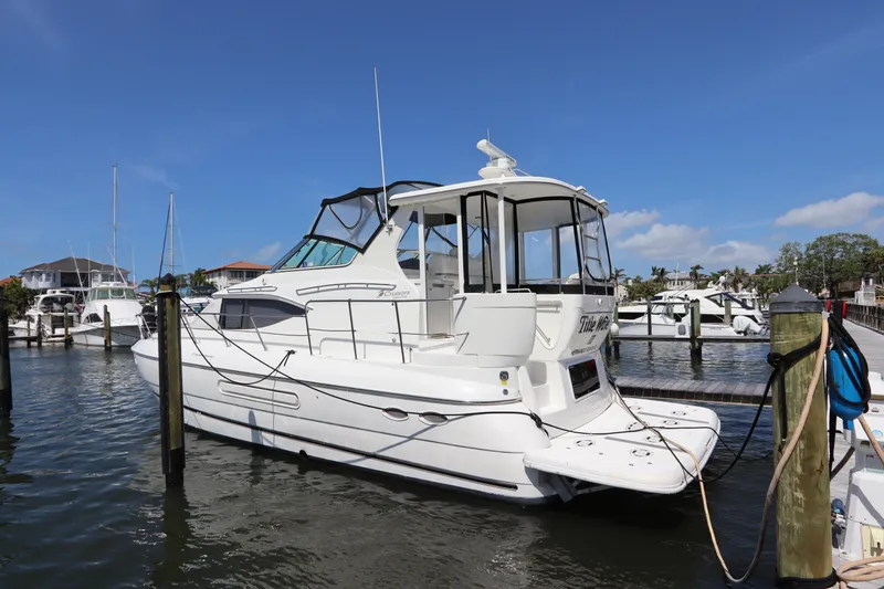  Yacht Photos Pics 2000 Cruisers Yachts 4450 Express Motoryacht docked in a marina under clear skies.