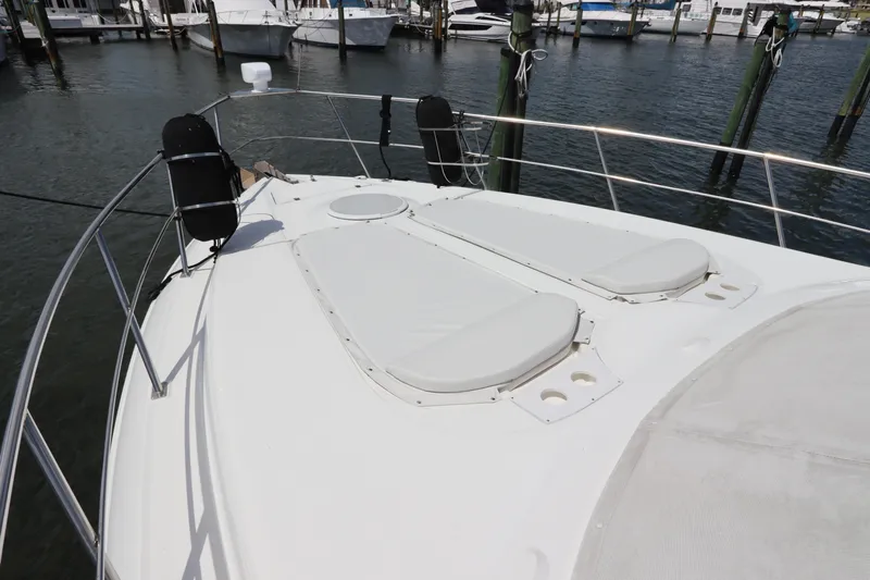  Yacht Photos Pics 2000 Cruisers Yachts 4450 Express Motoryacht bow with sun pads at marina.