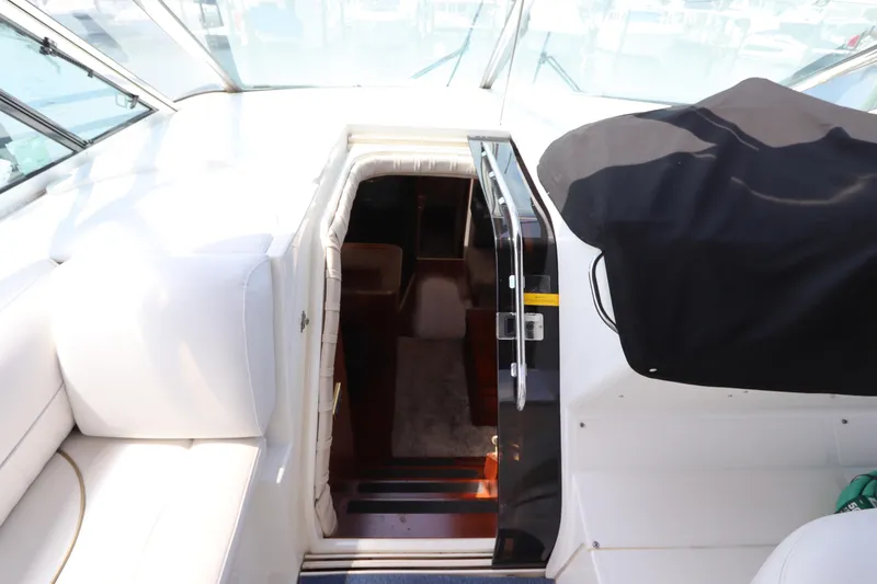  Yacht Photos Pics 2000 Cruisers Yachts 4450 Express Motoryacht interior entrance with white seating and covered controls.