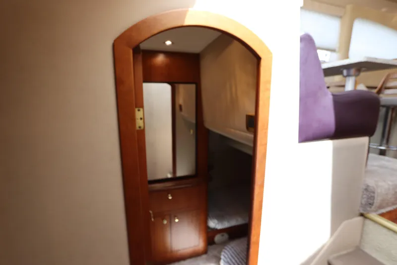  Yacht Photos Pics Interior of 2000 Cruisers Yachts 4450 Express Motoryacht with wooden door and cozy cabin.