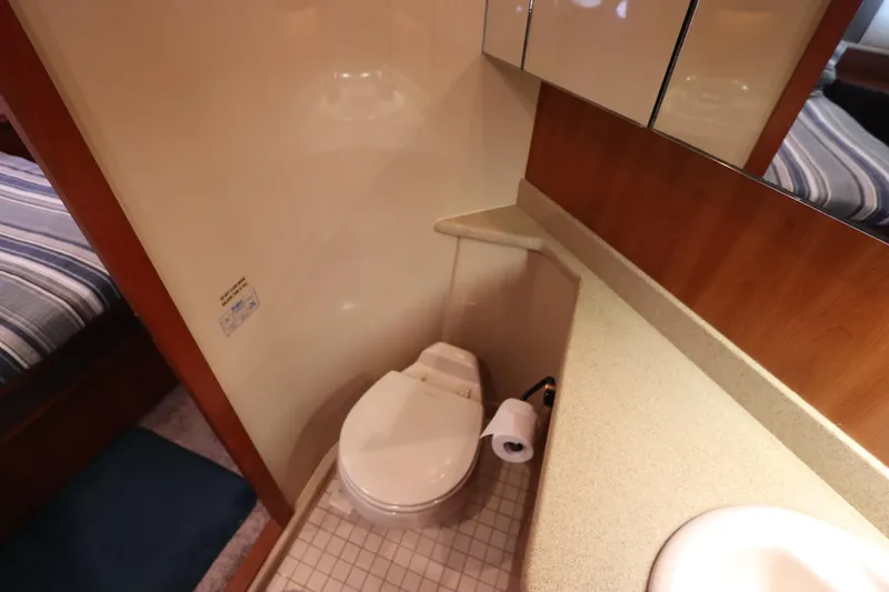  Yacht Photos Pics Bathroom interior of 2000 Cruisers Yachts 4450 Express Motoryacht, featuring toilet and sink.