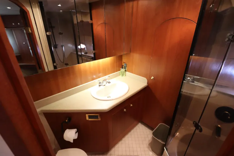  Yacht Photos Pics Luxurious bathroom in 2000 Cruisers Yachts 4450 Express Motoryacht with wood accents and modern fixtures.