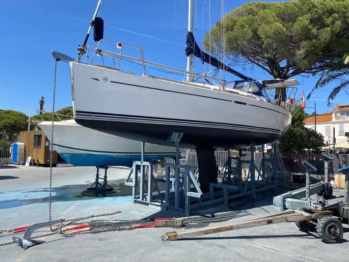  Yacht Photos Pics 2006 Dufour 34 Performance sailboat on dry dock, ready for maintenance under clear blue sky.