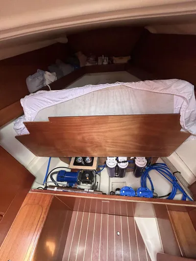  Yacht Photos Pics Interior view of 2006 Dufour 34 Performance sailboat, showcasing engine compartment and wooden paneling.