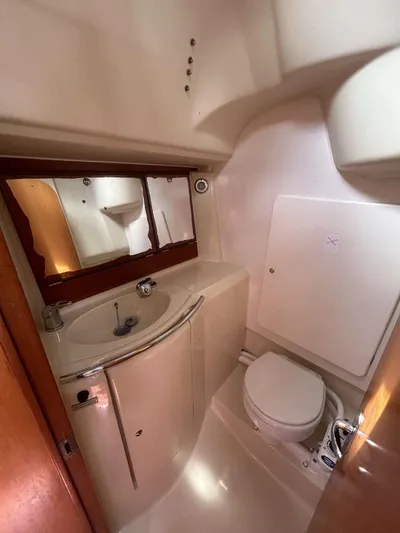  Yacht Photos Pics 2006 Dufour 34 Performance yacht bathroom with sink, mirror, and toilet.