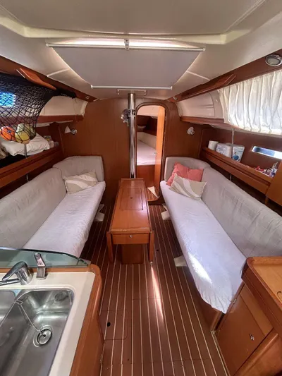  Yacht Photos Pics Interior of 2006 Dufour 34 Performance sailboat with cozy seating and wooden finishes.