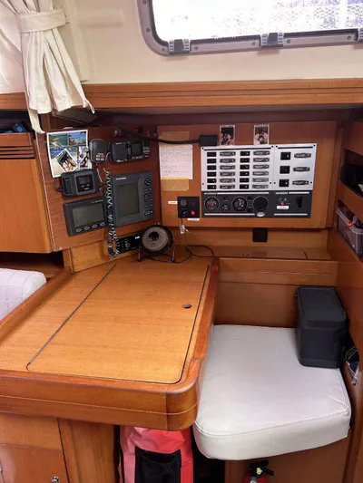  Yacht Photos Pics Navigation station inside 2006 Dufour 34 Performance yacht, featuring control panels and seating.