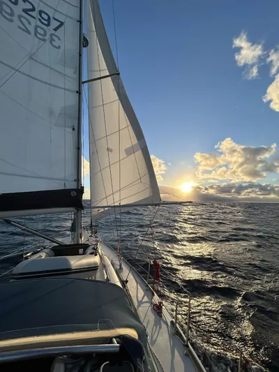  Yacht Photos Pics Sailing Dufour 34 Performance 2006 at sunset on open sea.