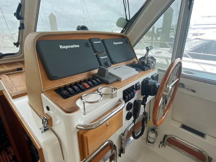  Yacht Photos Pics 2014 Back Cove 41 helm with Raymarine navigation system and wooden steering wheel.