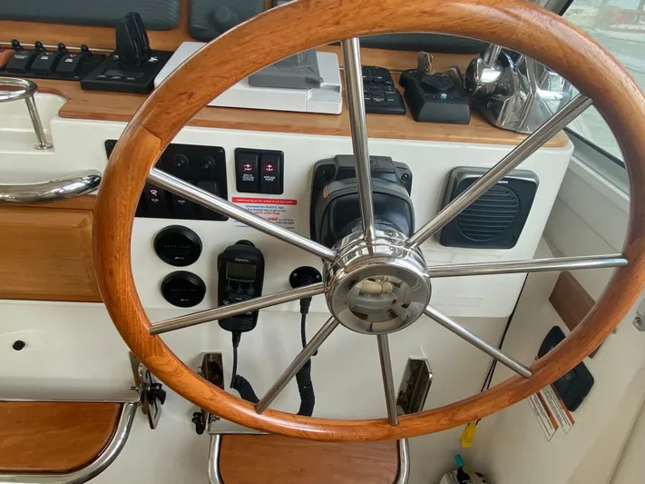 Yacht Photos Pics Steering wheel of a 2014 Back Cove 41 boat, featuring wooden and metal design.