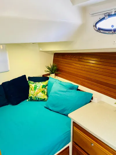  Yacht Photos Pics Cozy cabin interior of 2014 Back Cove 41 with vibrant cushions and wooden accents.