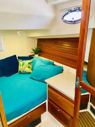  Yacht Photos Pics 2014 Back Cove 41 cabin interior with teal bedding and wooden accents.