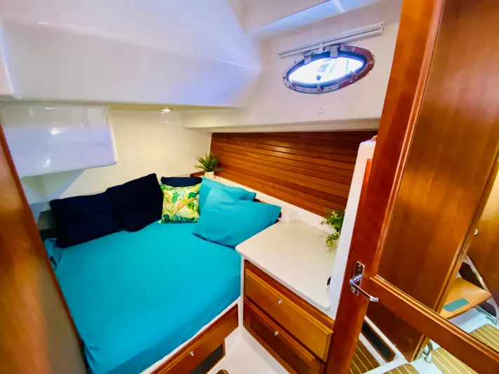  Yacht Photos Pics Cozy cabin interior of 2014 Back Cove 41 yacht with teal bedding and wooden accents.