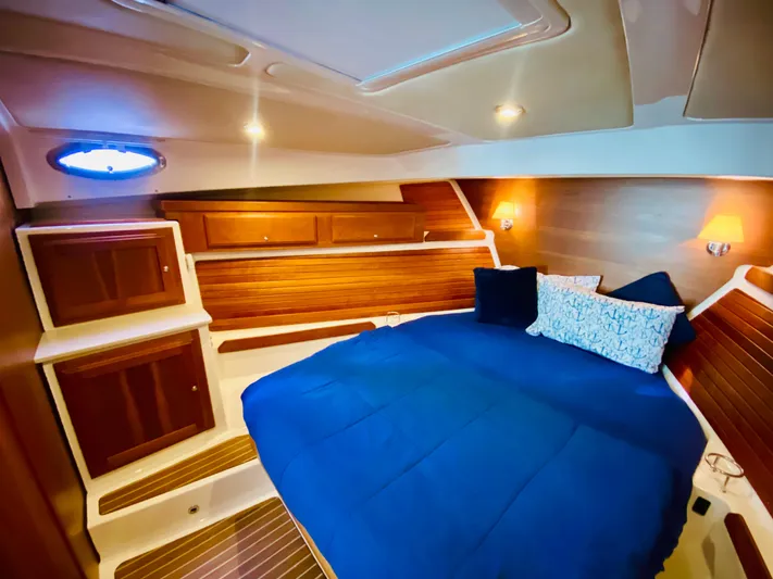  Yacht Photos Pics Luxurious cabin interior of 2014 Back Cove 41 yacht with blue bedding.