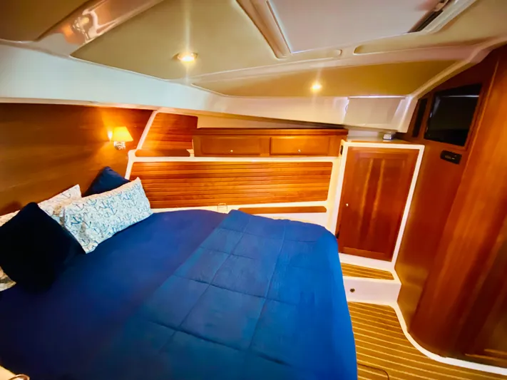  Yacht Photos Pics Luxurious cabin interior of 2014 Back Cove 41 yacht with blue bedding and wooden accents.