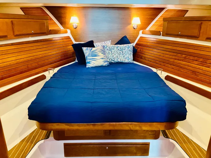  Yacht Photos Pics Luxurious cabin interior of 2014 Back Cove 41 yacht with cozy bedding and warm lighting.