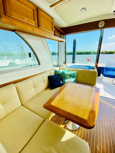  Yacht Photos Pics Interior of 2014 Back Cove 41 yacht with beige seating and wooden table.