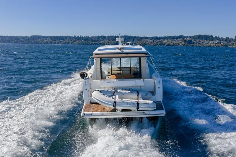 Bee's Knees Yacht Photos Pics 2017 Jeanneau NC 14 cruising on open water, rear view with clear skies.