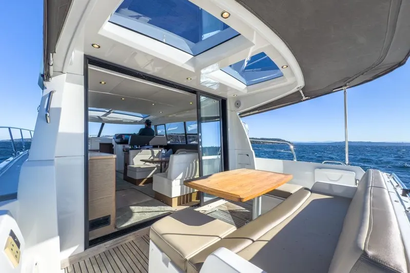 Bee's Knees Yacht Photos Pics 2017 Jeanneau NC 14 yacht interior with open seating and ocean view.