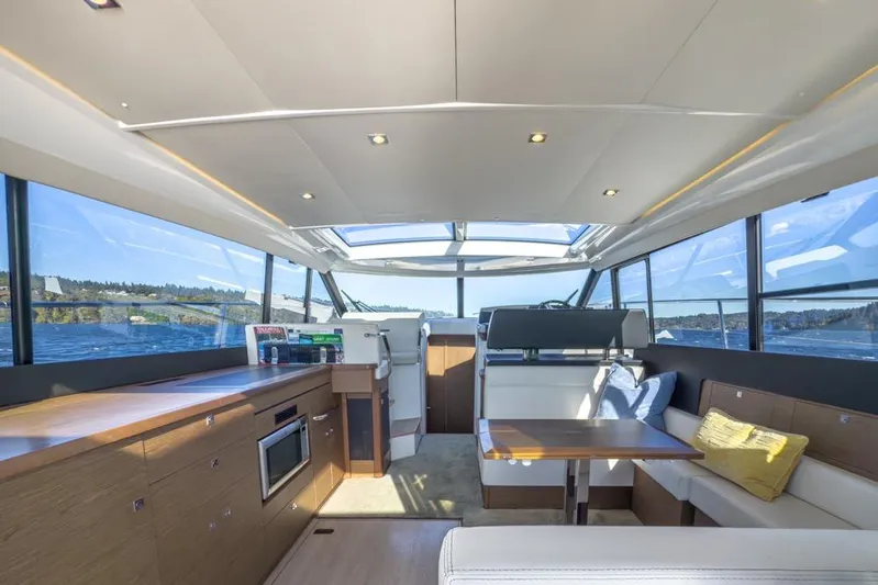 Bee's Knees Yacht Photos Pics Luxurious interior of 2017 Jeanneau NC 14 yacht with panoramic windows and modern amenities.