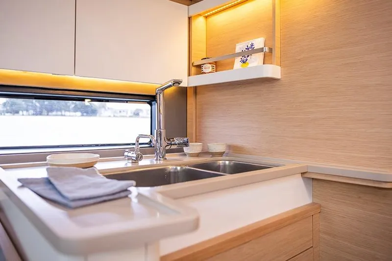 Yacht Photos Pics Modern kitchen interior of 2025 Dufour 44 yacht with sleek design and ample lighting.