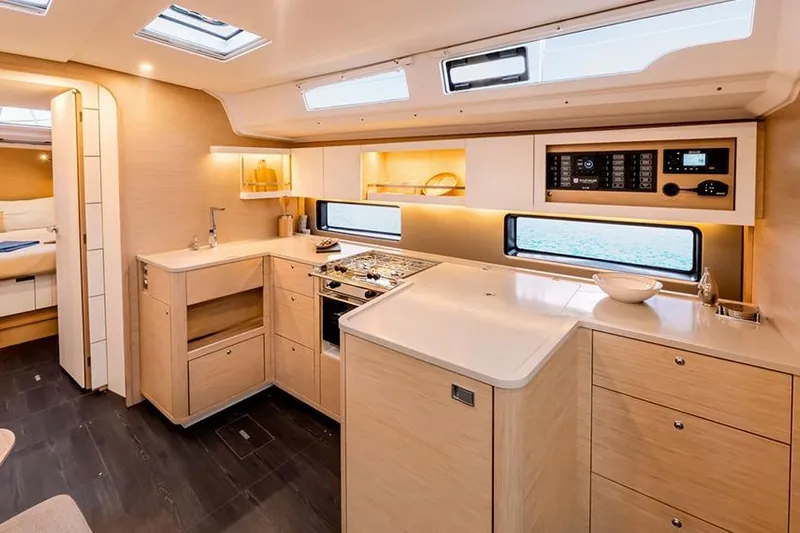  Yacht Photos Pics Modern kitchen interior of 2025 Dufour 44 yacht with sleek cabinetry and appliances.